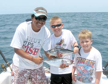 Kids catching bonita during sportfishing at Ixtapa Zihuatanejo, Mexico.